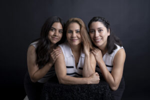 Family portrait session of mother and two daughters holding eachother